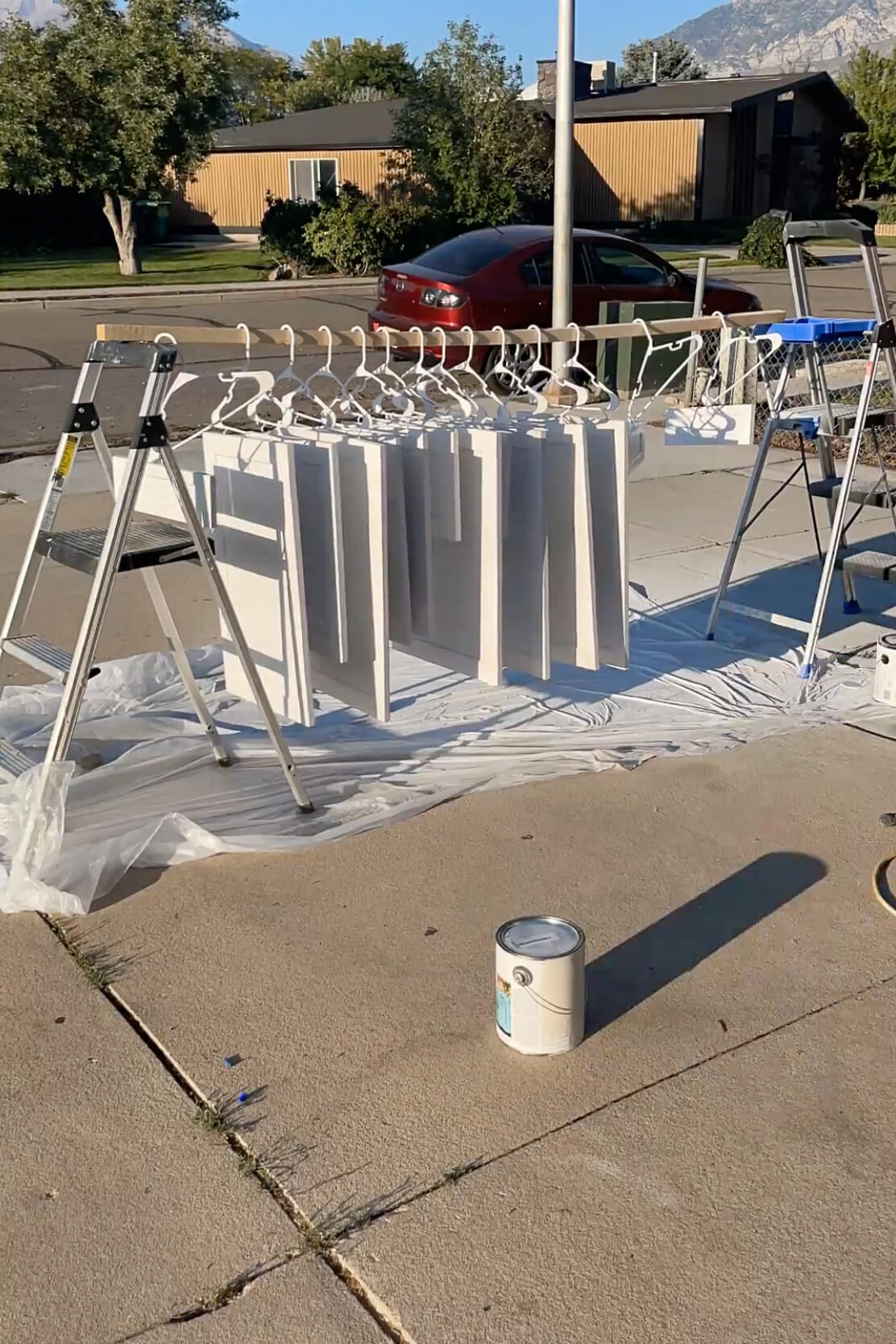 Hanging kitchen cabinet doors to paint with a sprayer.